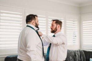 Gledswood Wedding Photo - Groom helps the groomsman with his tie