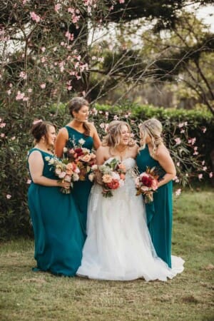 Gledswood Wedding Photo - the bride stands laughing with her bridesmaids