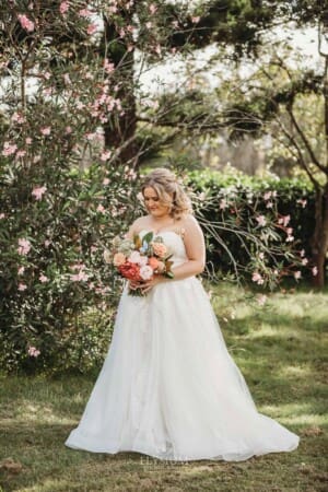 Gledswood Wedding Photo - the bride looks down at her flowers