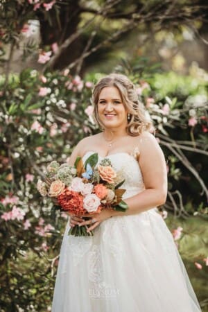 Gledswood Wedding Photo - the bride poses with her bouquet