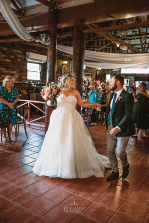 Gledswood Wedding Photo - bride and groom entering the wedding reception