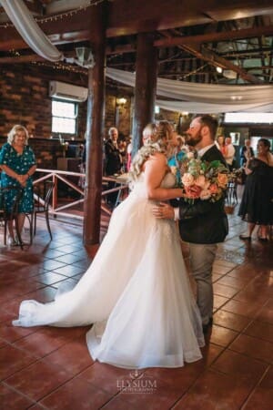 Gledswood Wedding Photo - bride and groom entering the wedding reception