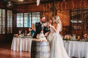 Gledswood Wedding Photo - bride and groom cut their wedding cheese cake