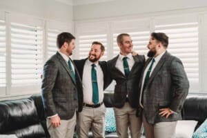 Gledswood Wedding Photo - Groom stands with his arms around the groomsmen
