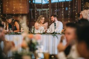 Gledswood Wedding Photo - bride and groom toast after cutting the cake