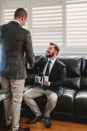 Gledswood Wedding Photo - Groom receives a gift from the bride