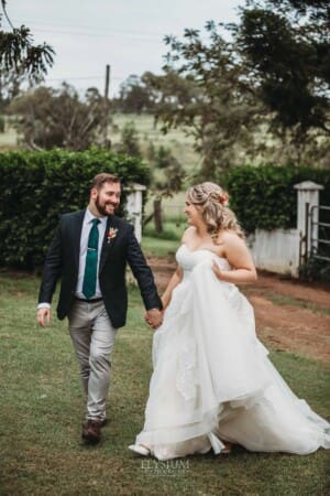 Gledswood Wedding Photo - bride and groom walk across the Gledswood homestead lawn