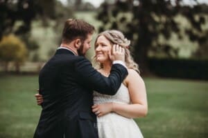 Gledswood Wedding Photo - groom sweeps the brides hair behind her ear