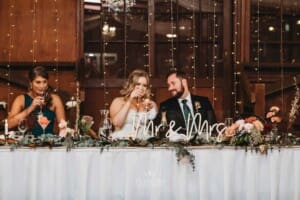 Gledswood Wedding Photo - bride and groom toast after the groomsman's speech