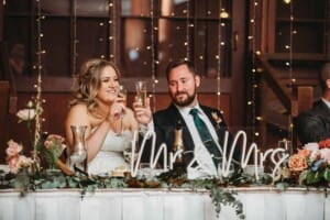 Gledswood Wedding Photo - bride and groom toast after the bridesmaid's speech