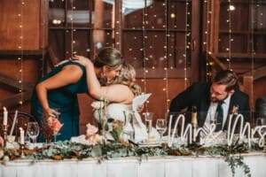 Gledswood Wedding Photo - bride hugs her bridesmaid after the speech