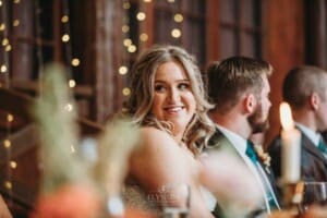 Gledswood Wedding Photo - bride smiles listening to the speeches