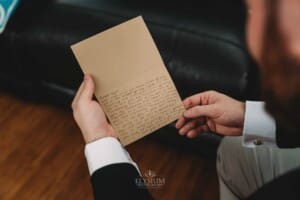 Gledswood Wedding Photo - Groom reads a letter from the bride