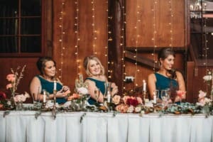 Gledswood Wedding Photo - bridesmaids grin as the groom makes his speech