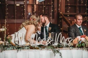 Gledswood Wedding Photo - the groom kisses the bride after his speech