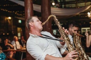 Gledswood Wedding Photo - saxophone player performs during the reception