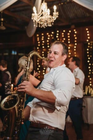 Gledswood Wedding Photo - saxophone player performs during the reception