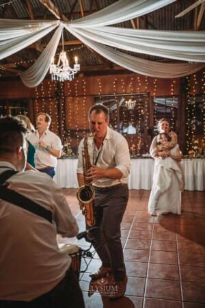Gledswood Wedding Photo - saxophone player performs during the reception