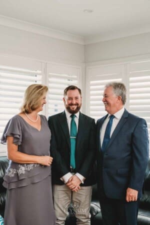 Gledswood Wedding Photo - Groom stands between his parents