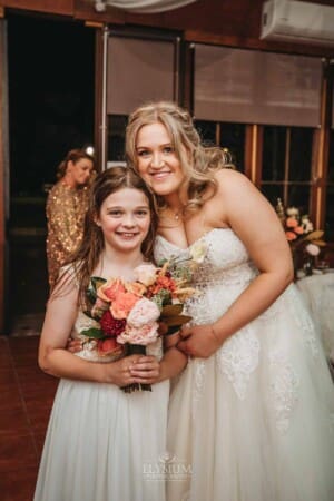 Gledswood Wedding Photo - a flower girl catches the brides bouquet