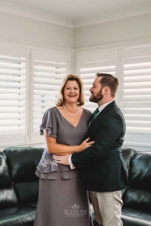 Gledswood Wedding Photo - Groom stands hugging his mum
