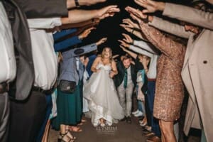 Gledswood Wedding Photo - the bride and groom run through the farewell arch