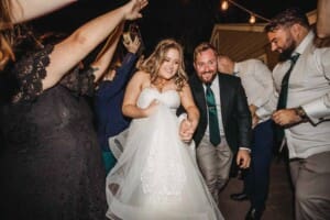 Gledswood Wedding Photo - the bride and groom run through the farewell arch