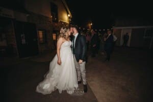 Gledswood Wedding Photo - the bride and groom kiss before leaving the reception
