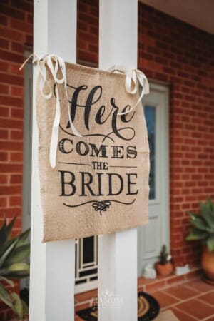 Gledswood Wedding Photo - A Wedding sign hangs outside the brides house