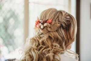 Gledswood Wedding Photo - Flowers stick out of the brides hair