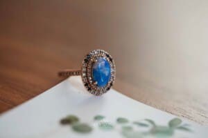 Gledswood Wedding Photo - Brides ring sits on their wedding invitation
