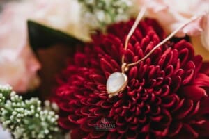 Gledswood Wedding Photo - Brides necklace sits in her wedding bouquet