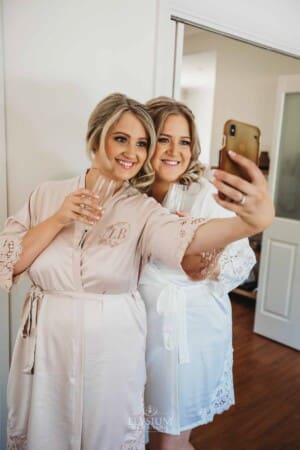 Gledswood Wedding Photo - Bridesmaid takes a selfie with the bride