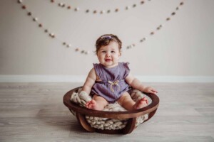 Cake Smash Session - baby girl sits in a wooden bowl