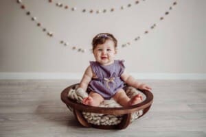 Cake Smash Session - baby girl sits in a wooden bowl