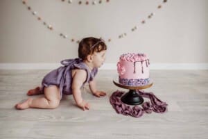 Cake Smash Session - baby girl crawls to look at her pink cake