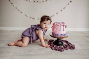 Cake Smash Session - baby girl crawls to her birthday cake