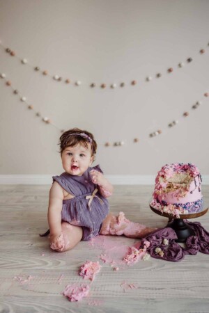 Cake Smash Session - baby girl smashes her pink first birthday cake