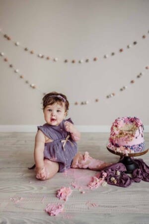 Cake Smash Session - baby girl smashes her pink first birthday cake