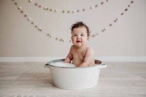 Cake Smash Session - baby girl sits in a bubbly tub