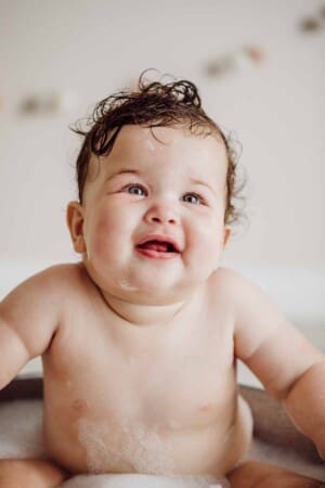 Cake Smash Session - baby girl cleans up her cake smash in a bubble bath