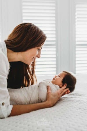 Baby Photography - a mother looks lovingly at her newborn daughter