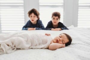 Baby Photography - little boys watch their newborn sister sleeping