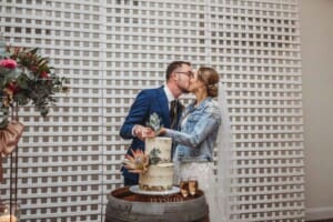 Burnham Grove Wedding - the bride and groom cut their wedding cake