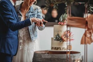 Burnham Grove Wedding - the bride and groom cut their wedding cake