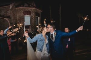 Burnham Grove Wedding - the bride and groom kiss at the end of their sparkler exit