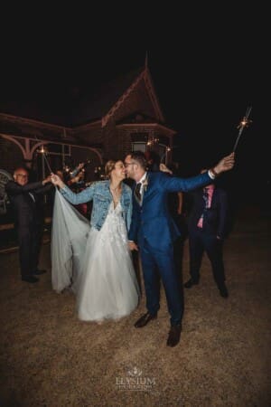 Burnham Grove Wedding - the bride and groom kiss at the end of their sparkler exit