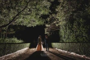 Burnham Grove Wedding - backlit night shot of the bride and groom standing on the driveway