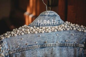 Burnham Grove Wedding - wedding date on the brides denim jacket