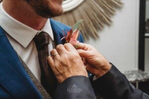 Burnham Grove Wedding - groom's father puts on his buttonhole flower